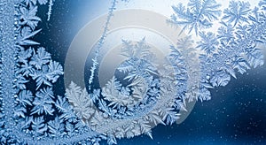 Intricate frost patterns cover a surface,