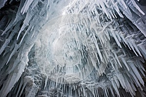 intricate ice formations jutting out from the ceiling of a glacier cave