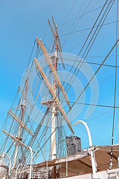 The Intricate Network of Ropes and Pulleys on a Tall Ship under a Clear Blue Sky photo