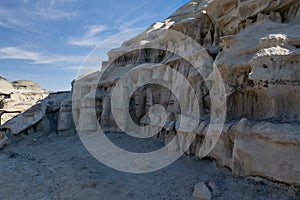 Intricate sandstone carvings line a Bisti Badlands wall