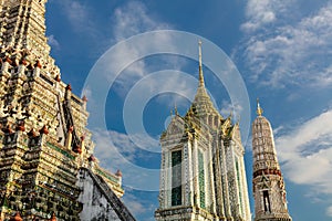 Temple and prangs, Wat Arun. Blue sky and clouds in background.