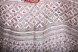 intricately designed arri and mirror work in white lehenga