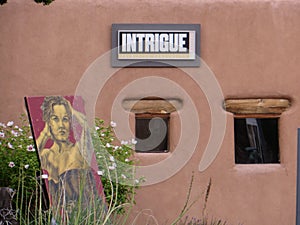 Intrigue. Sign and artwork outside Santa Fe New Mexico gallery.