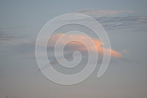 An intriguing cloud formation forms above the ocean shorline