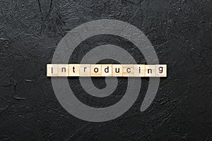 introducing word written on wood block. introducing text on table, concept