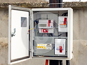 Introductory machine and electric energy meter in a dashboard on a pole on a land plot photo