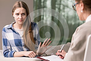 Introvert girl refusing to talk with specialist