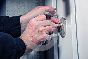 Intruder or burglar with lock picking tools