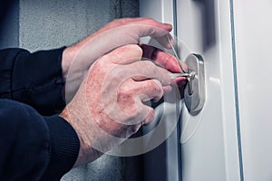 Intruder or burglar with lock picking tools photo