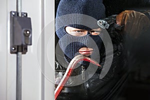 Intruder with crow bar and hand gun