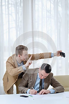 Intrusive colleague selfie work office ethics photo