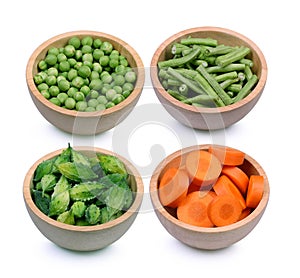 Inturkey berry,long bean,Momordica charantia fruits,carrot in wood bowl isolated white