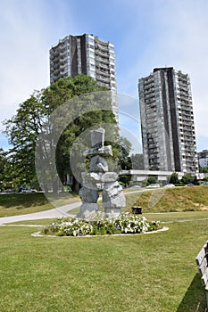 Inuksuk with condo buildings in back