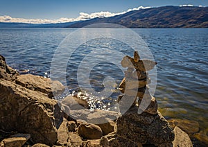 Inushuk standing on a rock in Kelowna Okanagan Lake BC. An inuksuk is a human-made stone landmark