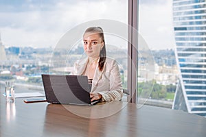 Invalid or disabled young business woman person sitting wheelchair working in office on a laptop