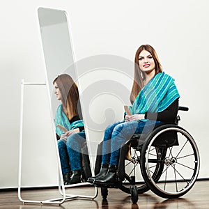 Invalid girl on wheelchair combing hair