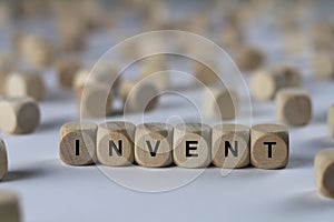 Invent - cube with letters, sign with wooden cubes