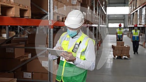 Inventory manager doing stocktaking in storehouse