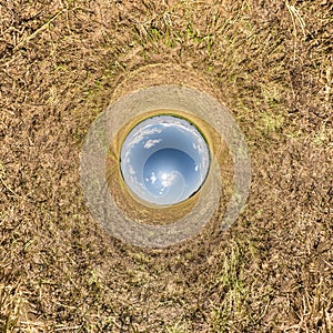 Inversion of blue little planet transformation of spherical panorama 360 degrees. Spherical abstract aerial view on yellow field