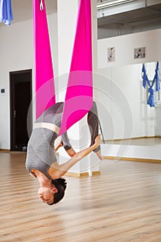 Inversion bow pose in aero anti gravity yoga. Aerial exercises