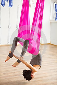 Inversion bow pose in aero anti gravity yoga. Aerial exercises