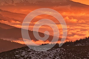 Inversion clouds from Mala Chochula peak in Low Tatras during winter sunrise