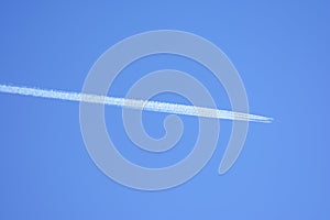 Inversion trace from the passenger liner at big height against the background of the clear blue sky