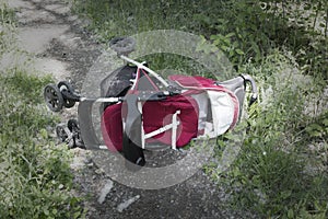 Inverted baby carriage rests on a forest road, kidnapping a child, stealing children