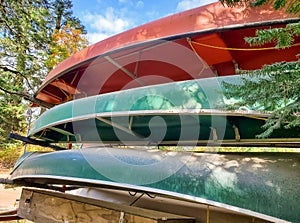 Inverted colorful canoes boats on shore.Stacked together on the beach