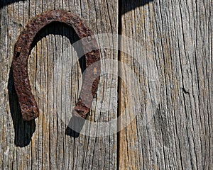 An inverted horse shoe on a barn wall
