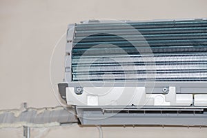 Inverter Air conditioning service, repair & maintenance concept. The specialist cleans and repairs the wall air conditioner.