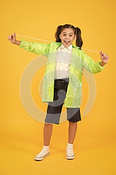 Invest in durable kids rainwear to keep children out in fresh air. Waterproof concept. Small schoolgirl wear water