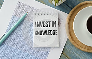 invest in knowledge. text on white notepad paper