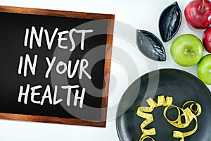 Invest in your health , Healthy lifestyle concept with diet and fitness , Get fit in  , fitness equipment and healthy food