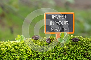 Invest in your health text on small blackboard