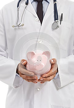 Invest in your healthcare savings today. Cropped image of a doctor holding a porcelain piggybank.