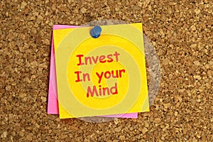 invest in your mind postit on corkboard