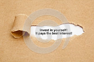 Invest In Yourself Quote Ripped Paper Concept photo