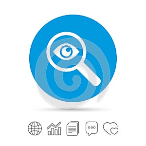 Investigate icon. Magnifying glass with eye. photo