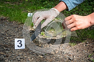 Investigator collects evidence - crime scene investigation