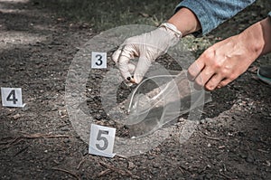 Investigator collects evidence - crime scene investigation