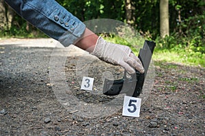 Investigator collects evidence - crime scene investigation