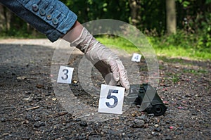 Investigator collects evidence - crime scene investigation