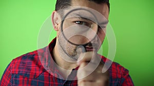 Investigator looking with magnifying glass green screen background