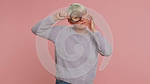 Investigator researcher woman with magnifying glass near face, looking into camera with big zoom eye