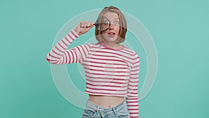 Investigator researcher woman with magnifying glass near face, looking into camera with big zoom eye