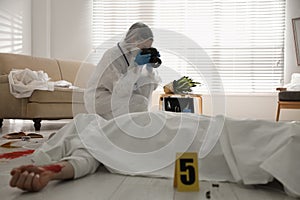 Investigator working at crime scene with dead body