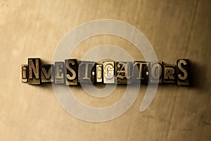 INVESTIGATORS - close-up of grungy vintage typeset word on metal backdrop