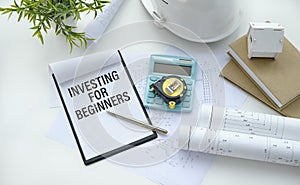 INVESTING FOR BEGINNERS text on white paper on gray background