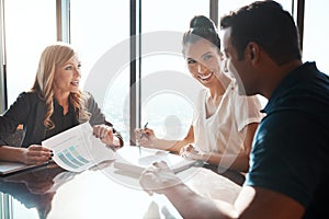Investing in the financial health of their marriage. a young couple meeting with a financial planner in a modern office.